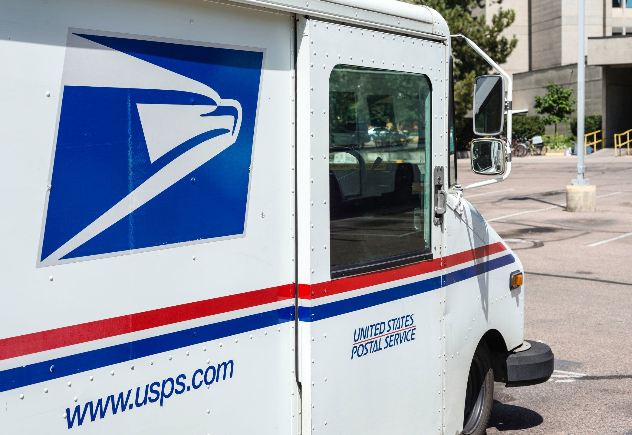 Fort Collins, Colorado, USA - August 24, 2013: A delivery vehicle parked at the United States Post Office in downtown Fort Collins. With almost 600,000 employees, the United States Postal Service is the second largest civilian employer in the United States.