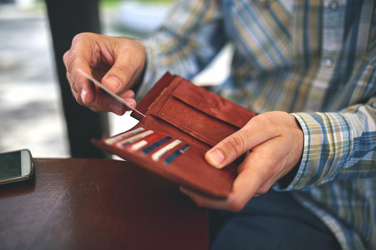 man pulling a credit card from wallet