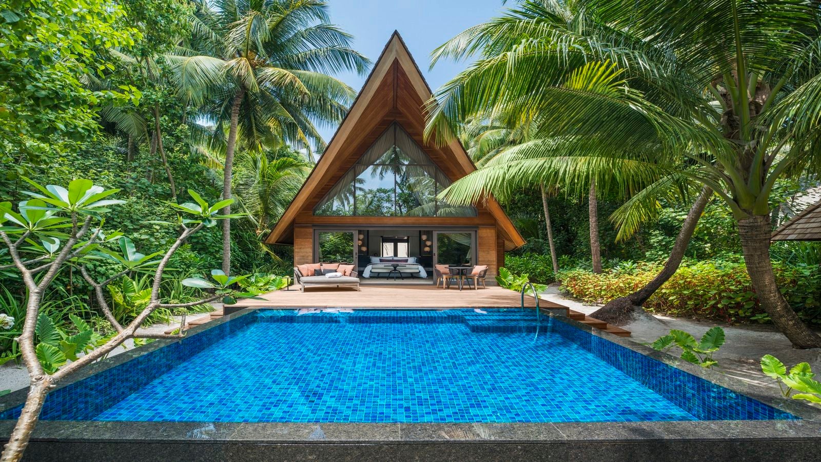 a private plunge pool at a villa surrounded by palm trees