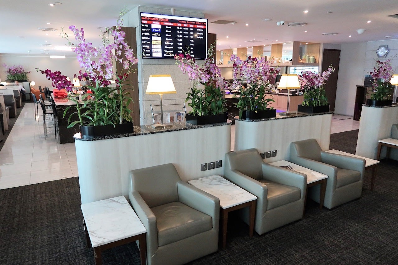 Seating and flower arrangements in empty airport lounges