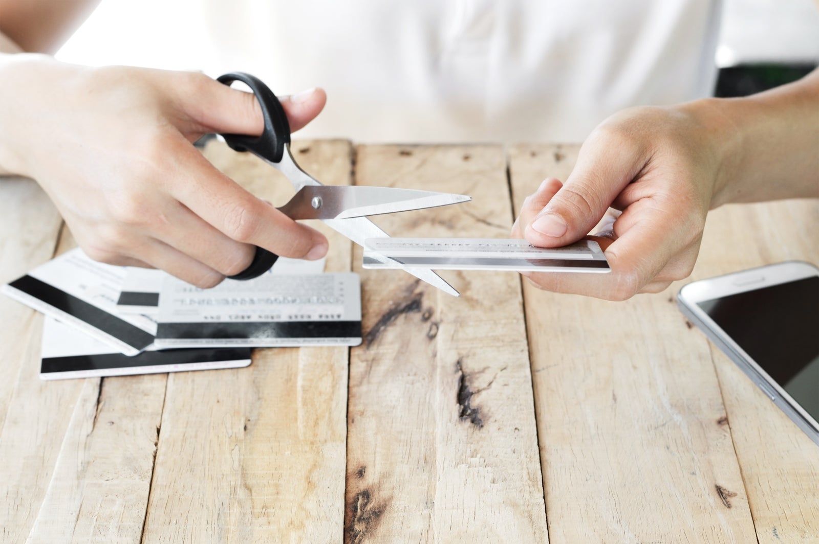 cutting credit card with scissors