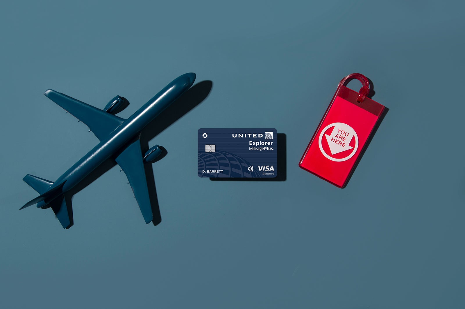a credit card between a model plane and luggage tag