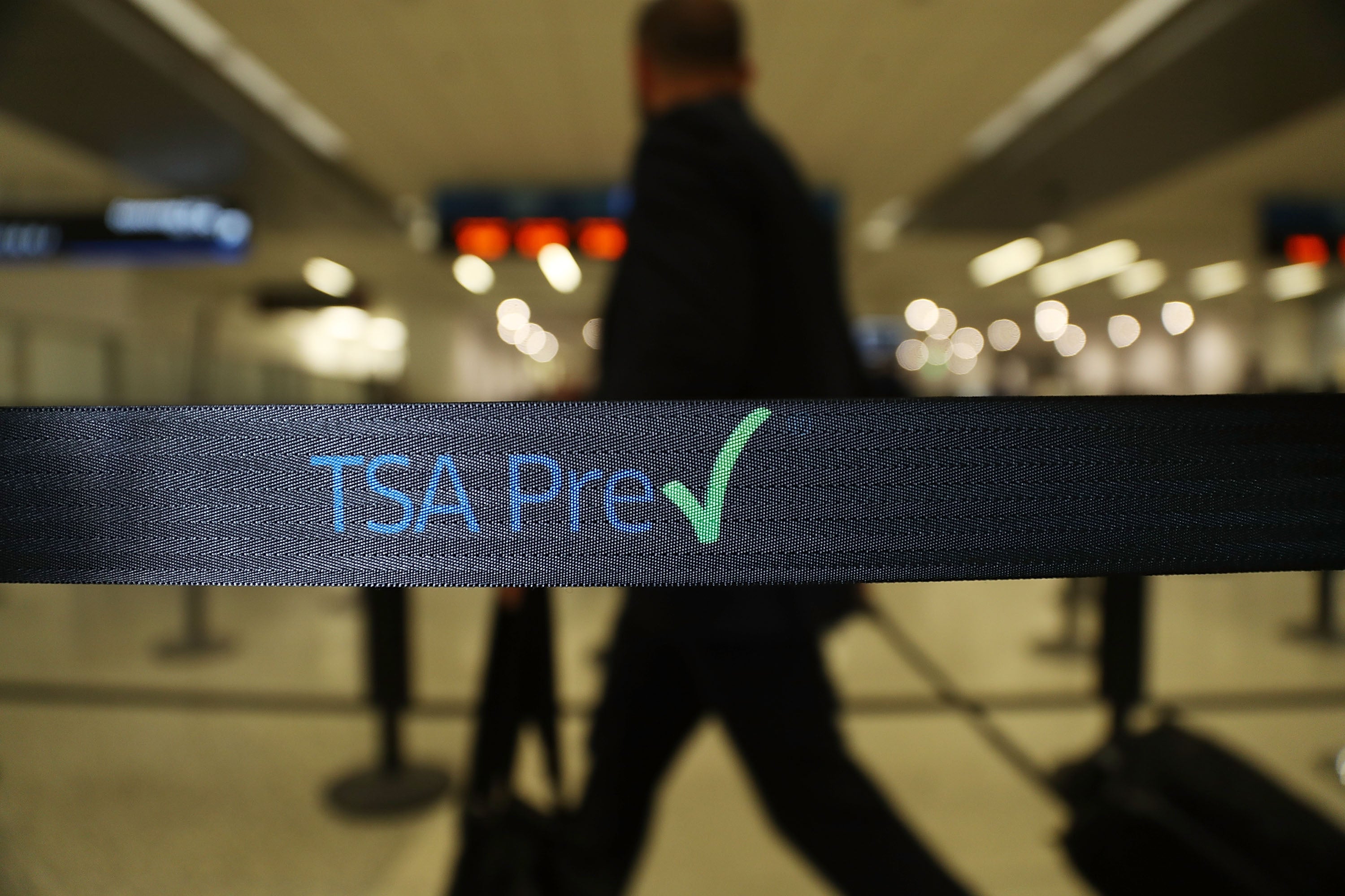 Travelers go through the TSA PreCheck security point in Miami