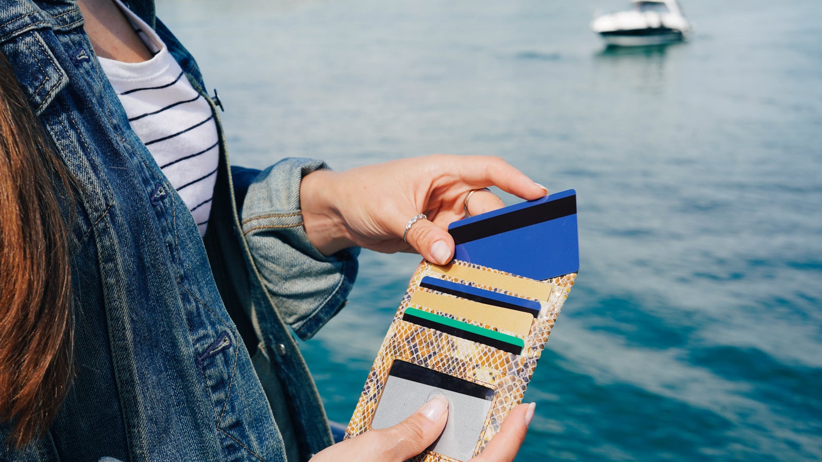 Woman holding wallet with multiple credit cards