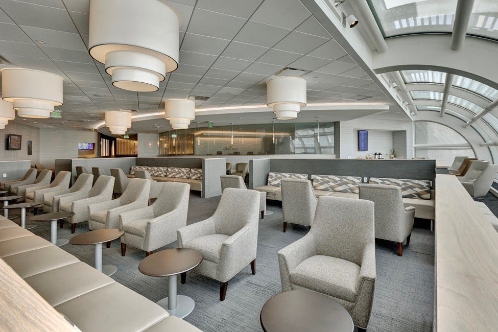 white and light gray-colored furniture inside an airport lounge