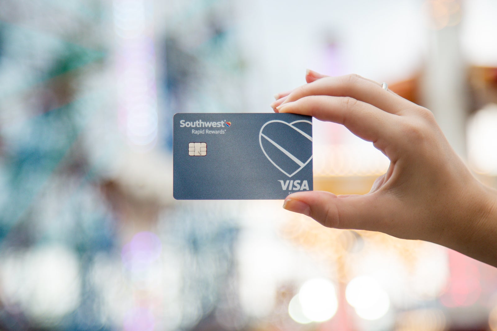 a hand holding a credit card