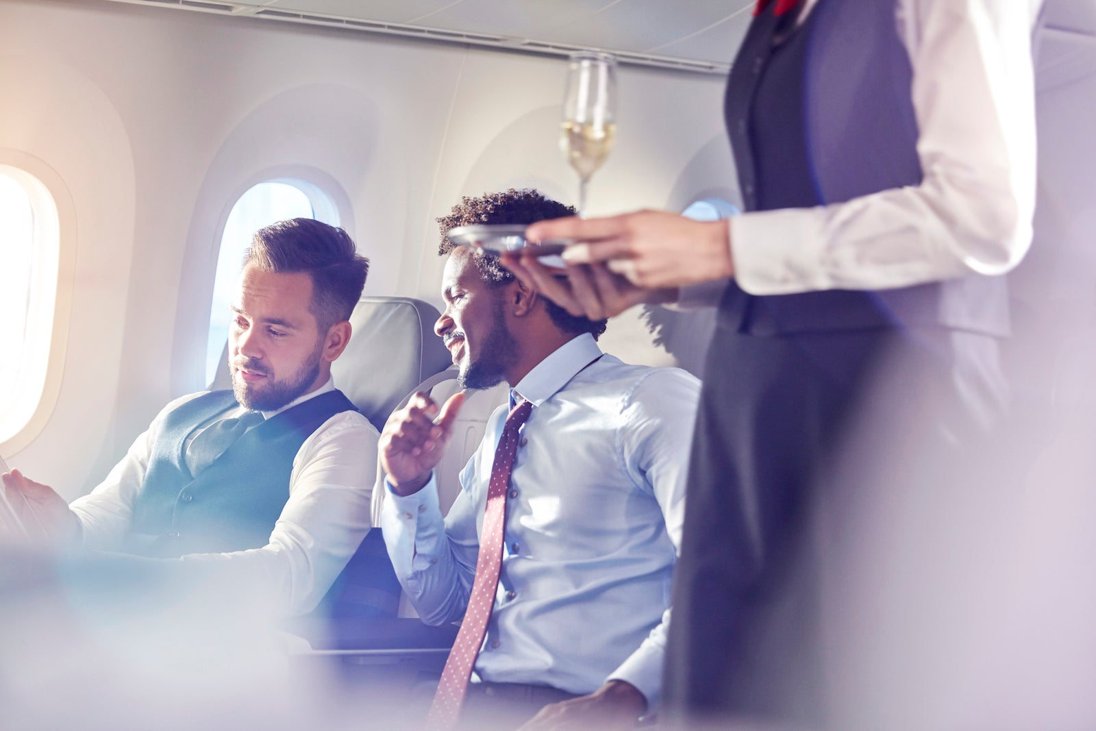 Men flying in a premium cabin