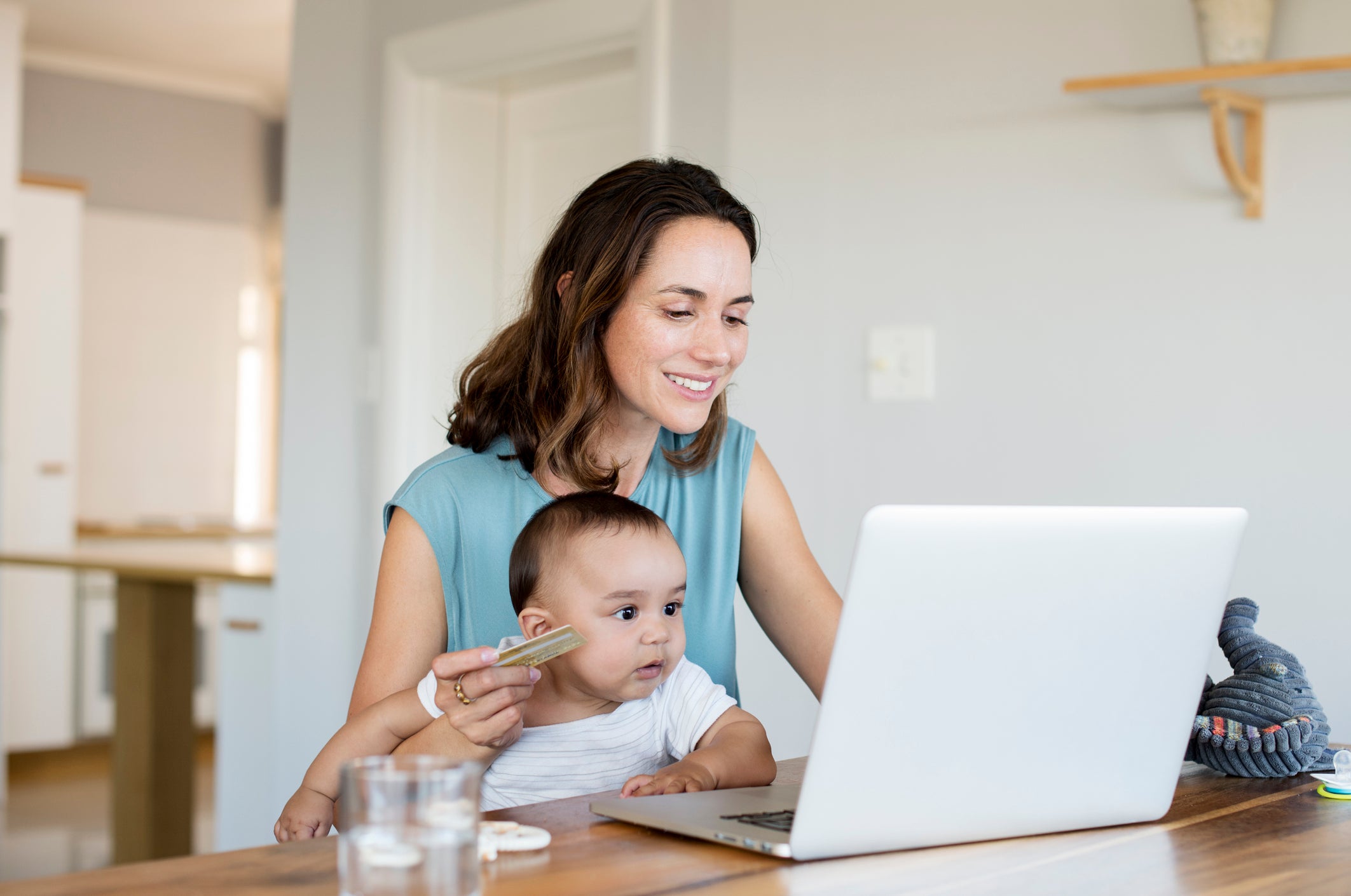 woman and baby with laptop and credit card