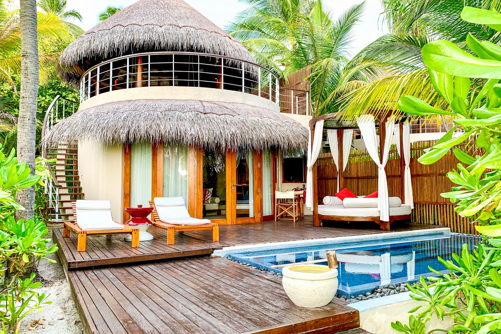a luxury beach hut next to a private dip pool