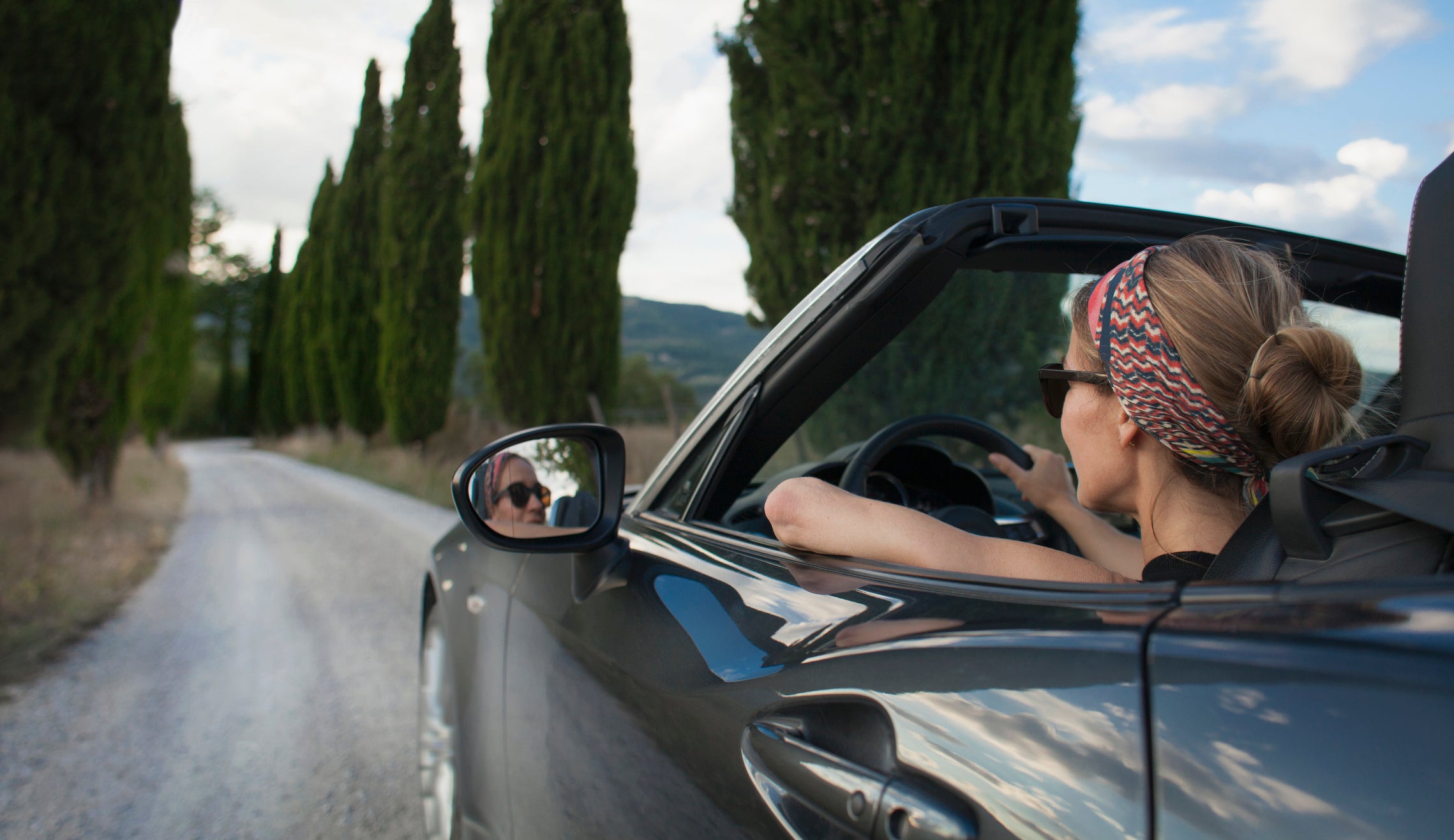 Women driving a convertible car