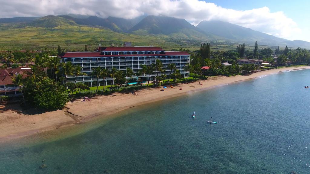 aerial view of Lahaina Shores along beach with mountains behind