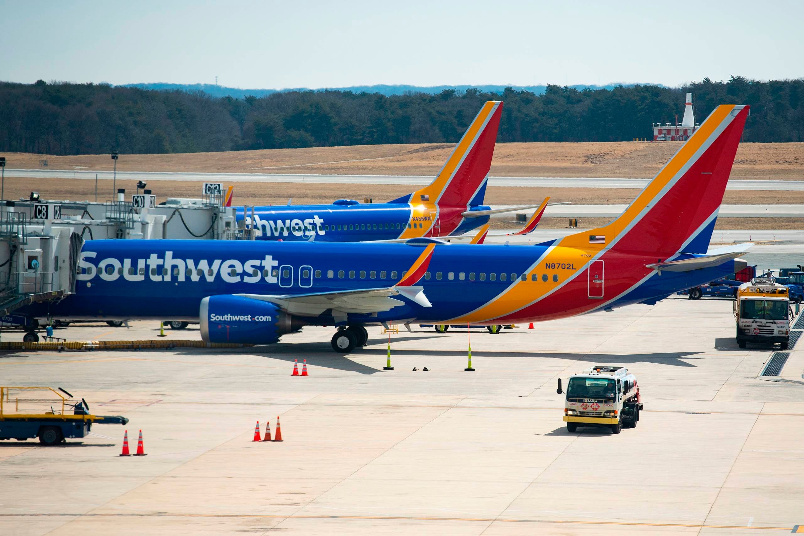 Southwest Airlines planes are parked at boarding gates