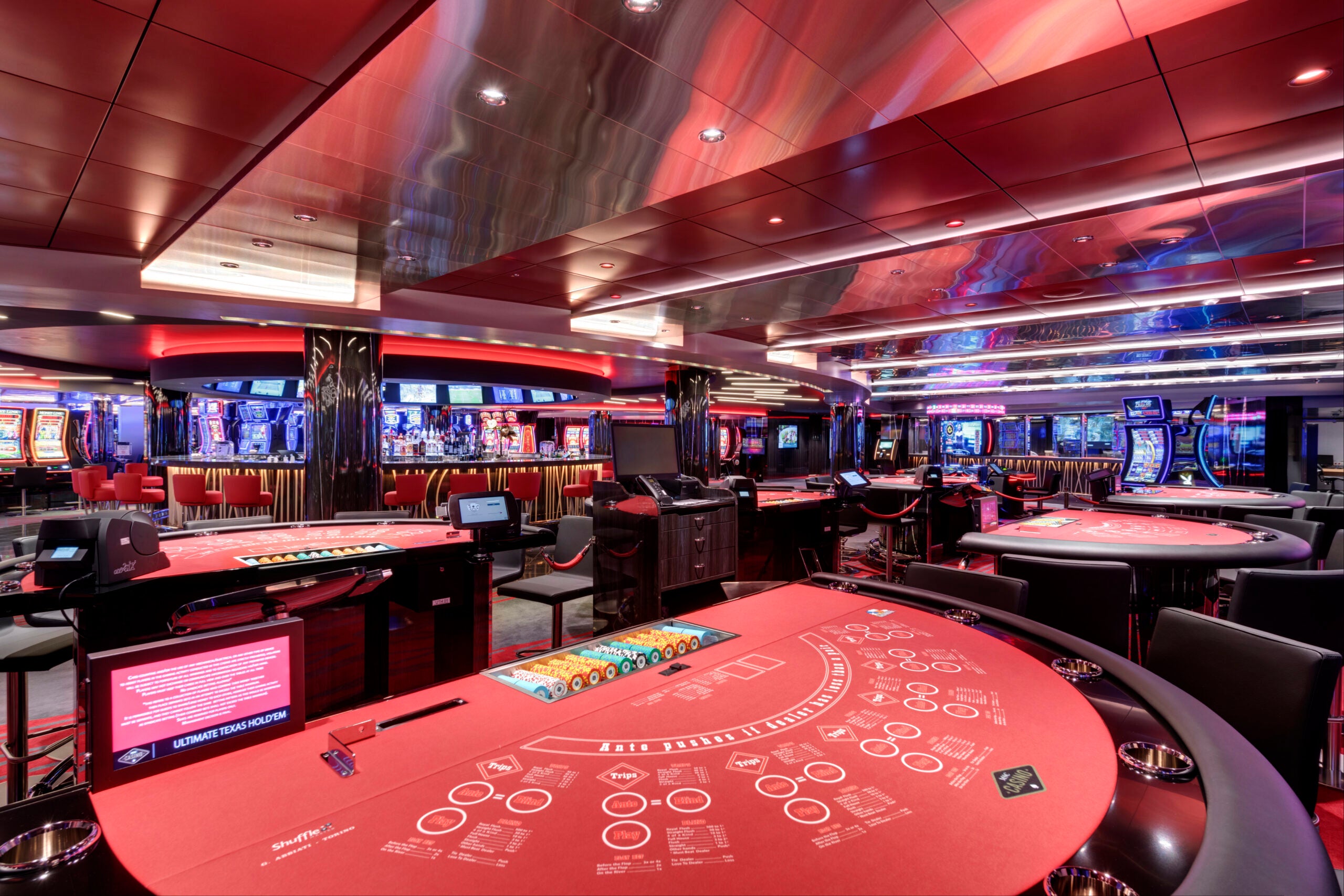 Cruise ship casino with gaming tables.