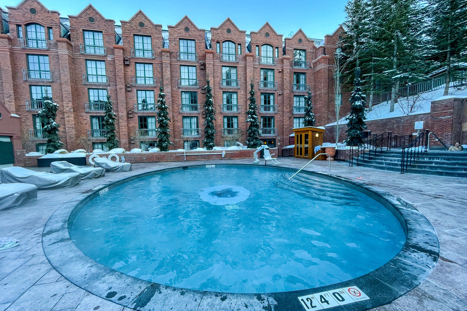 a hotel sits behind a hot tub