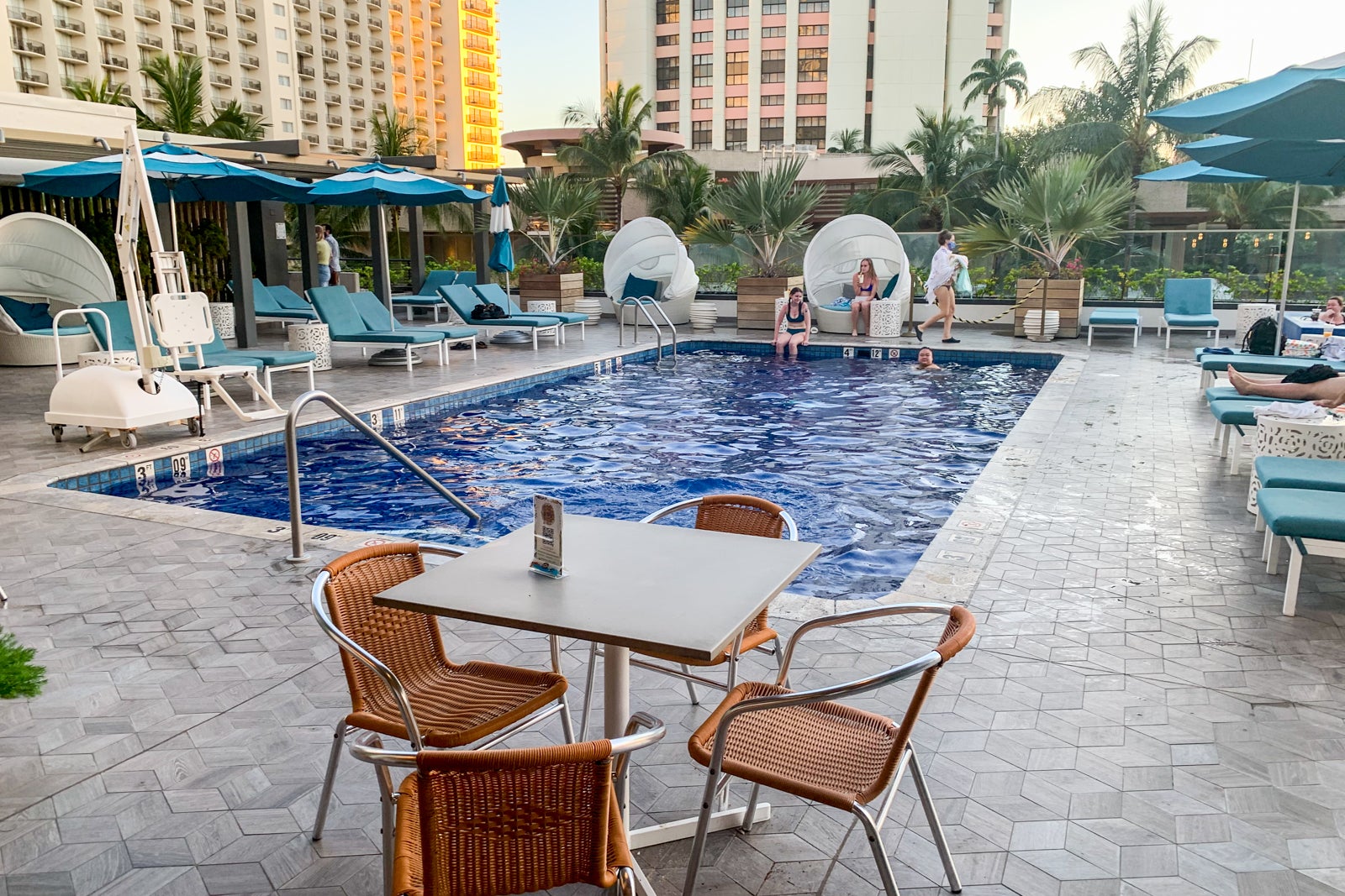 guests lounge around a hotel pool