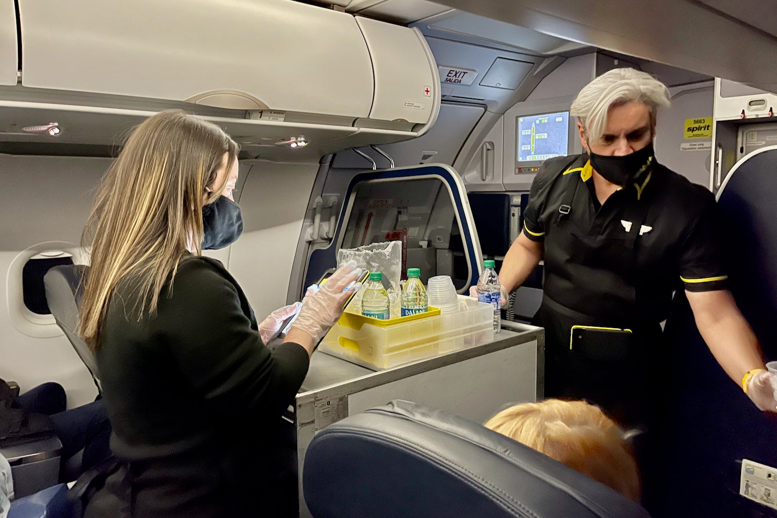 Flight attendants taking orders and charging cards on a Spirit flight