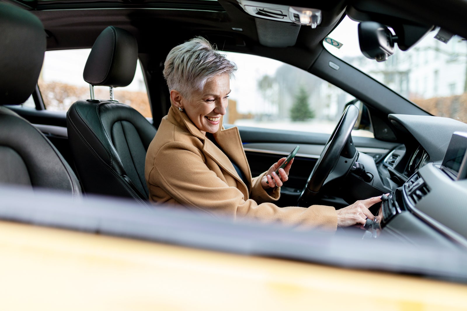 active women is using smart phone to start a sharing car