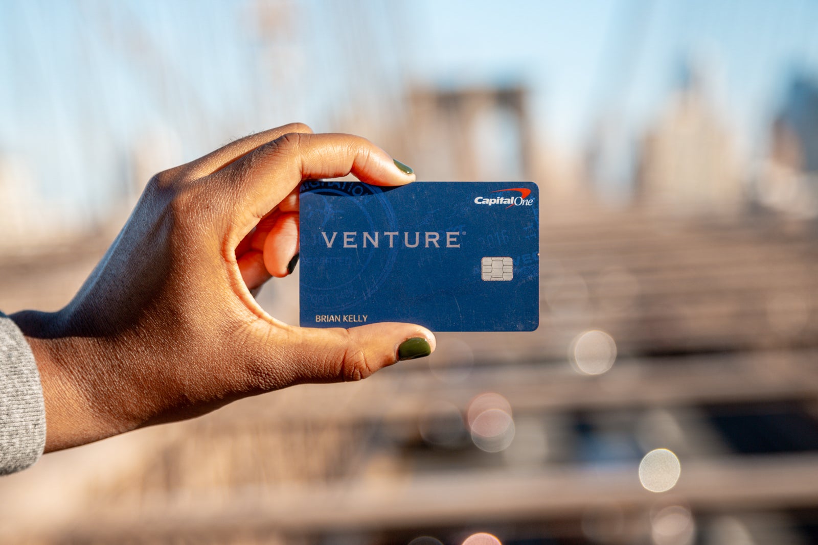hand holding Capital One Venture Rewards credit card