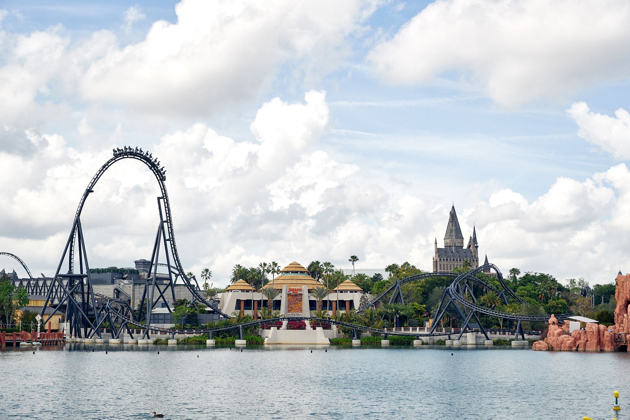 exterior shot of the Jurassic World velocicoaster from across the lagoon