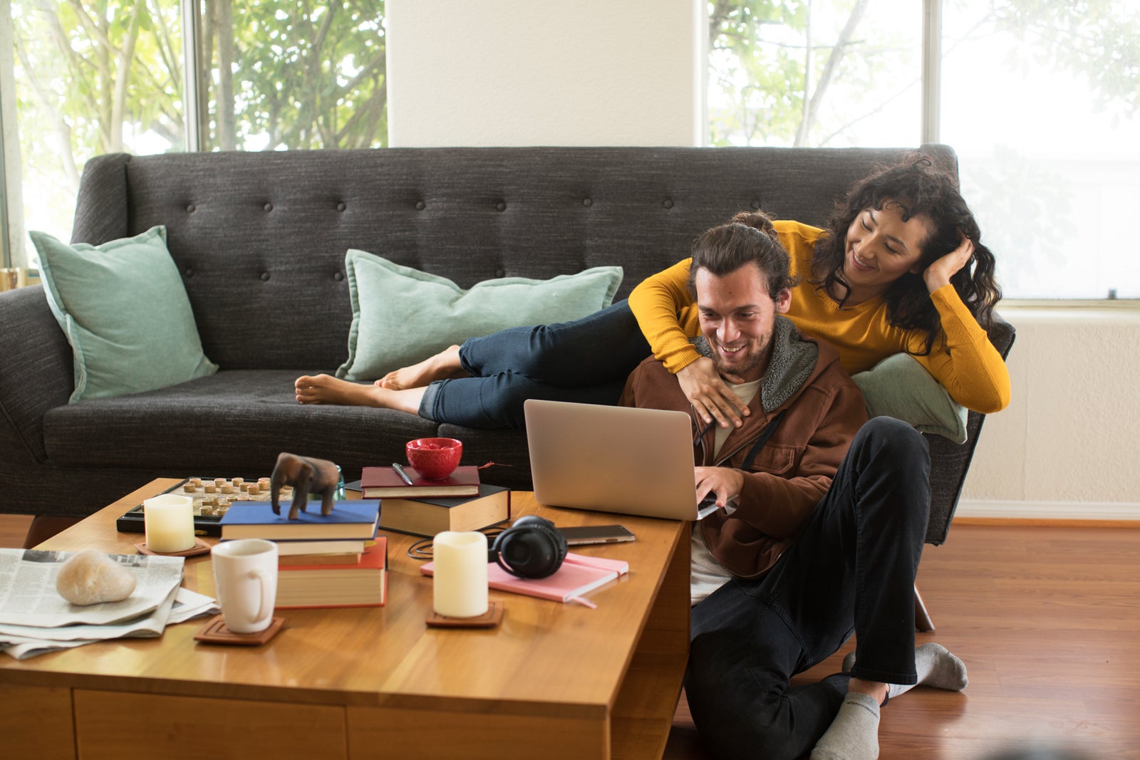 a couple uses a laptop to shop online