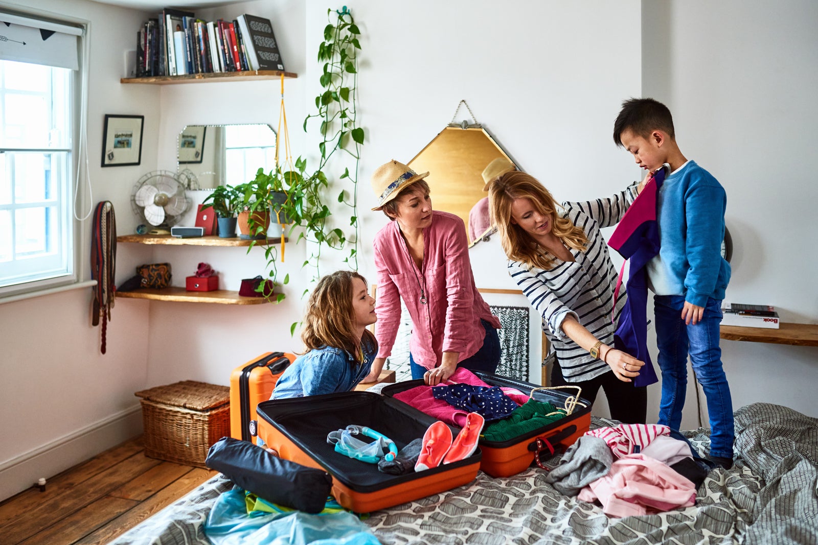 parents packing a suitcase with children