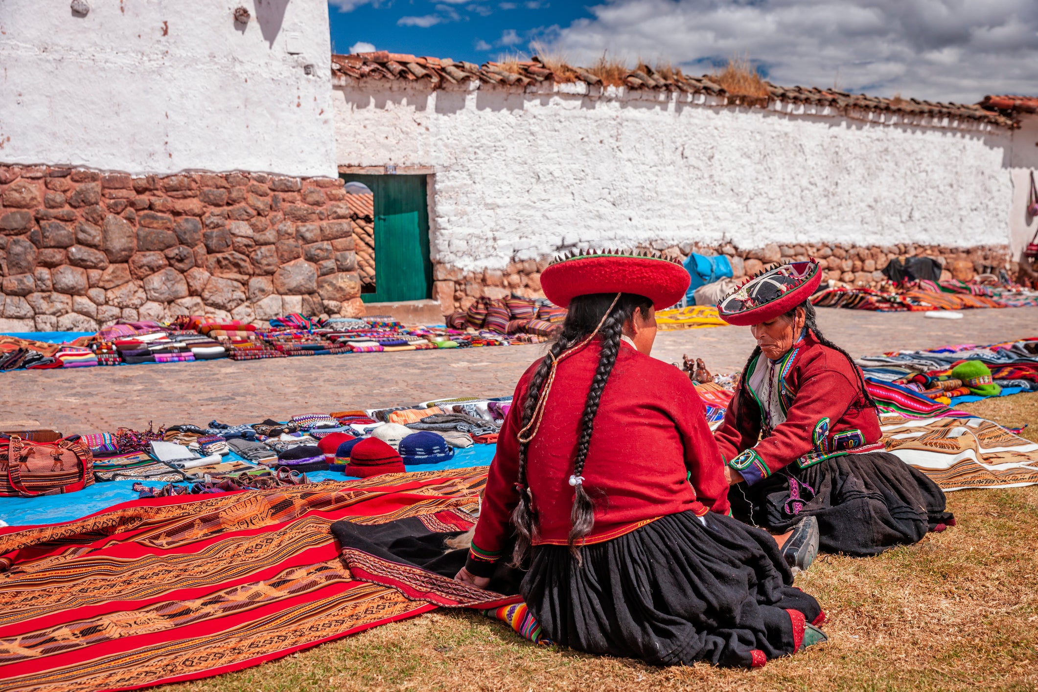 Peruvian women selling souvenirs at Inca ruins, Sacred Valley, Peru