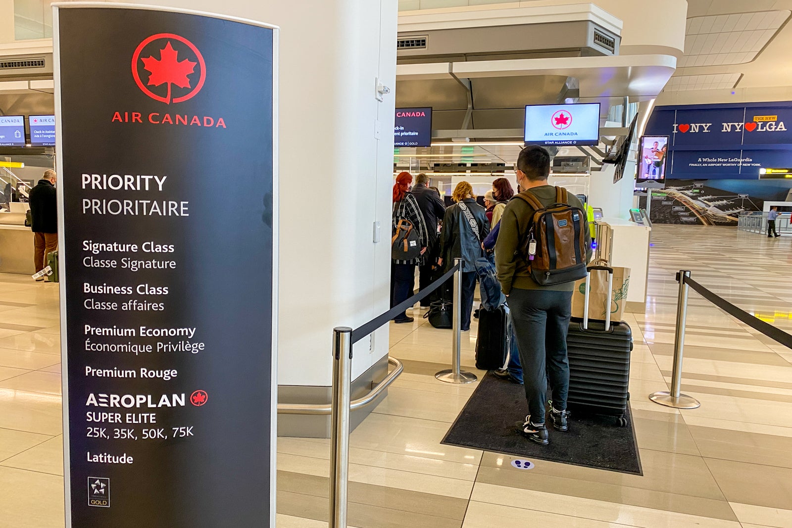 sign pointing to priority check-in lane