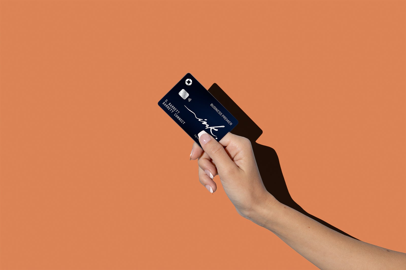 a hand holds a credit card