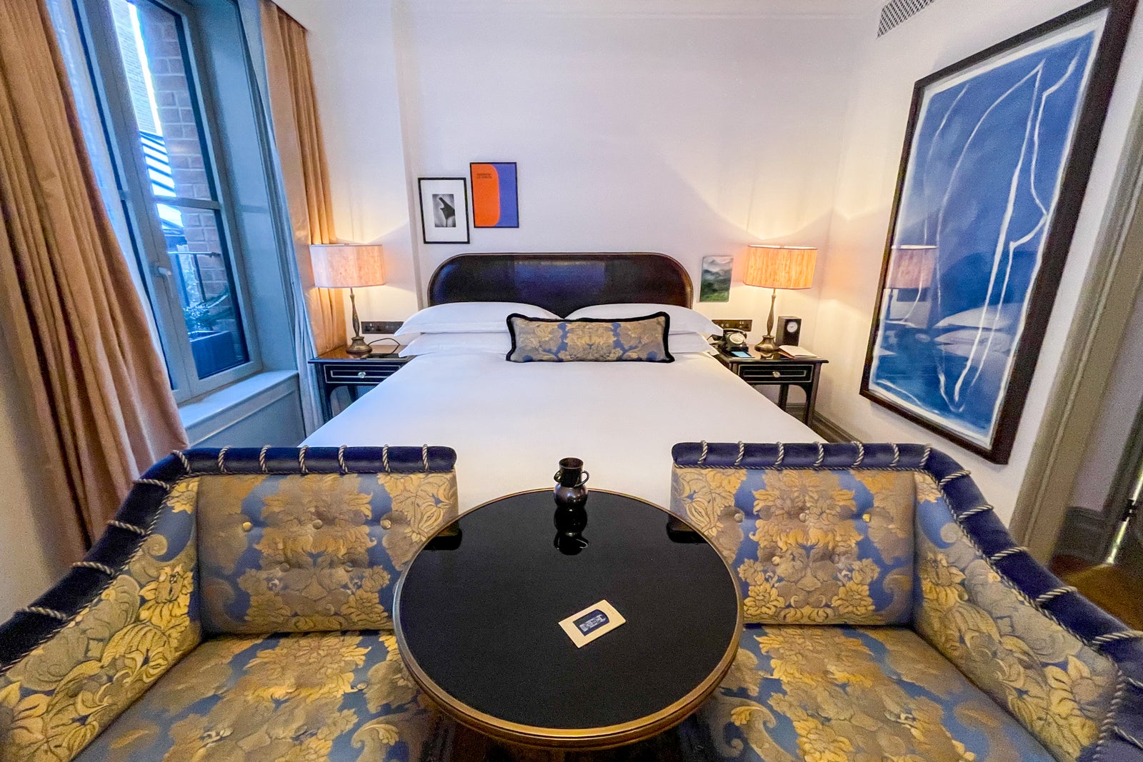 a hotel room with blue and gold furnishings