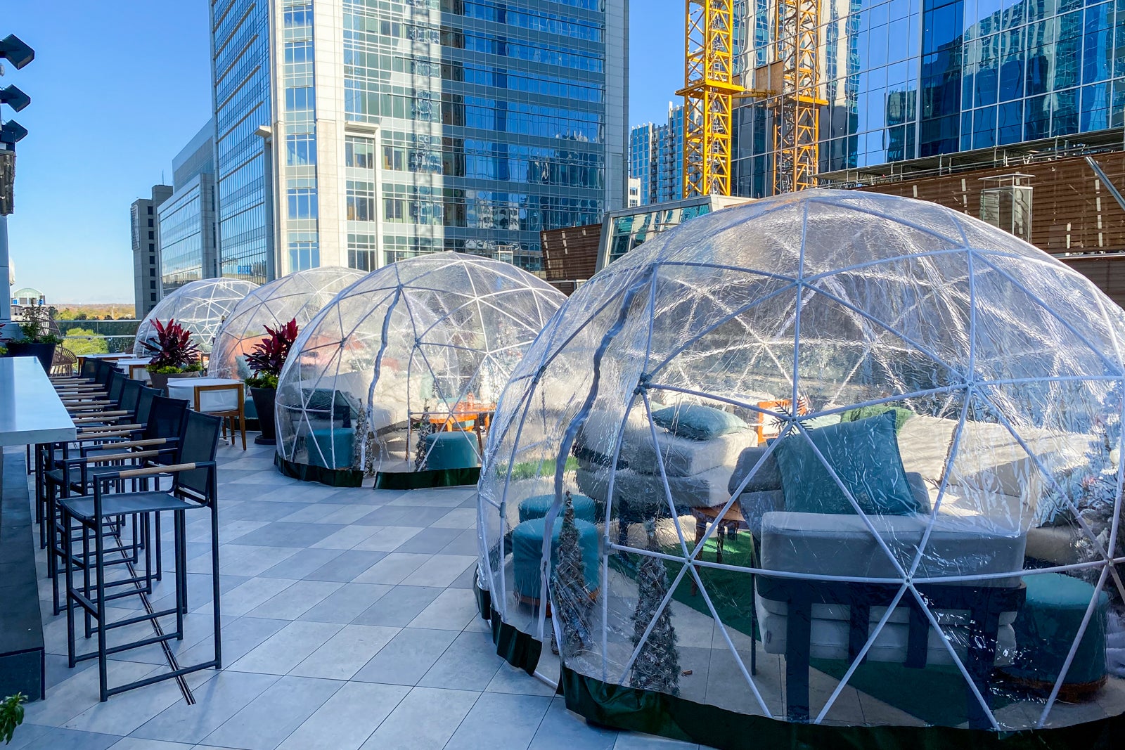 an outdoor seating area where each table is enclosed in a bubble