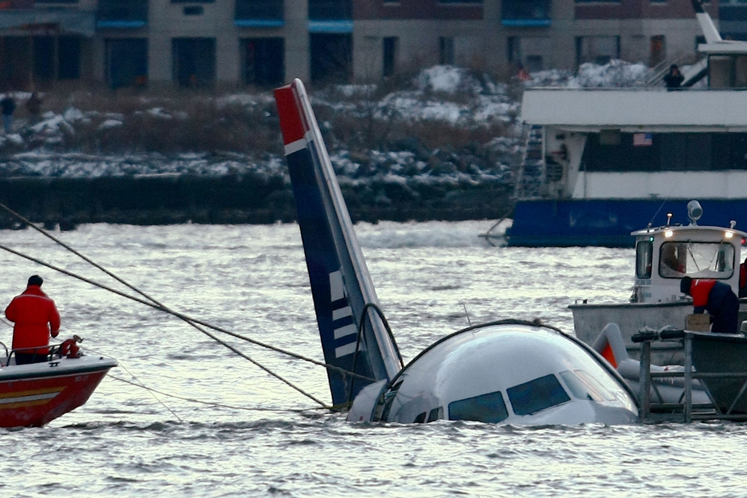 Rescue crews secure US Airways flight 1549 floating in the water