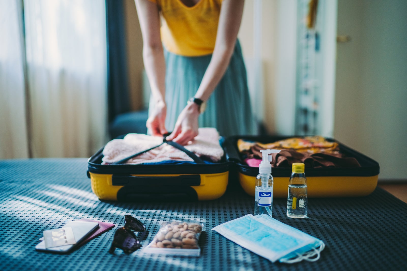 Woman packing a suitcase for travel