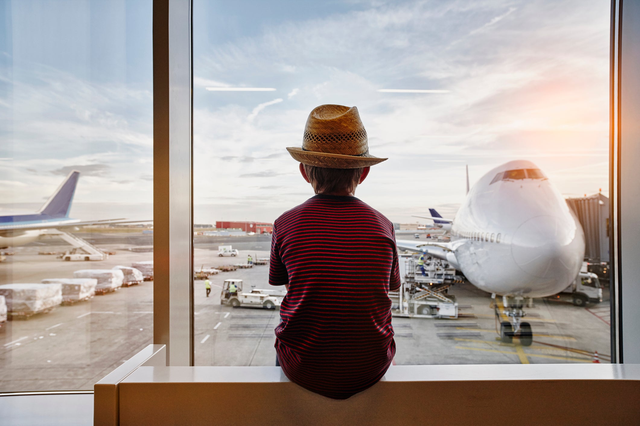 Kid watching planes at the airport
