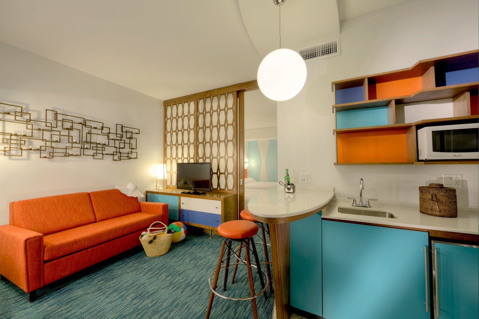 Living area of Universal's Cabana Bay Beach Resort with couch, kitchenette and television