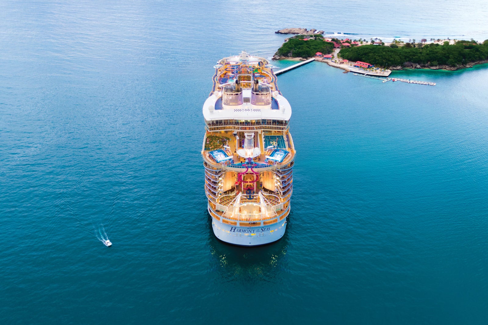 An aerial aft view of Royal Caribbean's Harmony of the Seas cruise ship at anchor in blue water