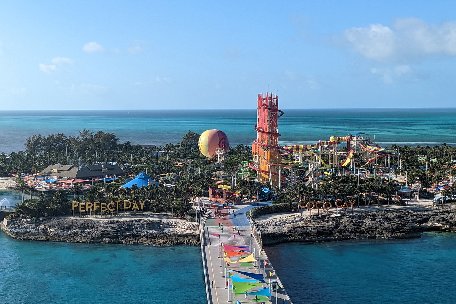 Island with tall waterslide tower and colorful balloon