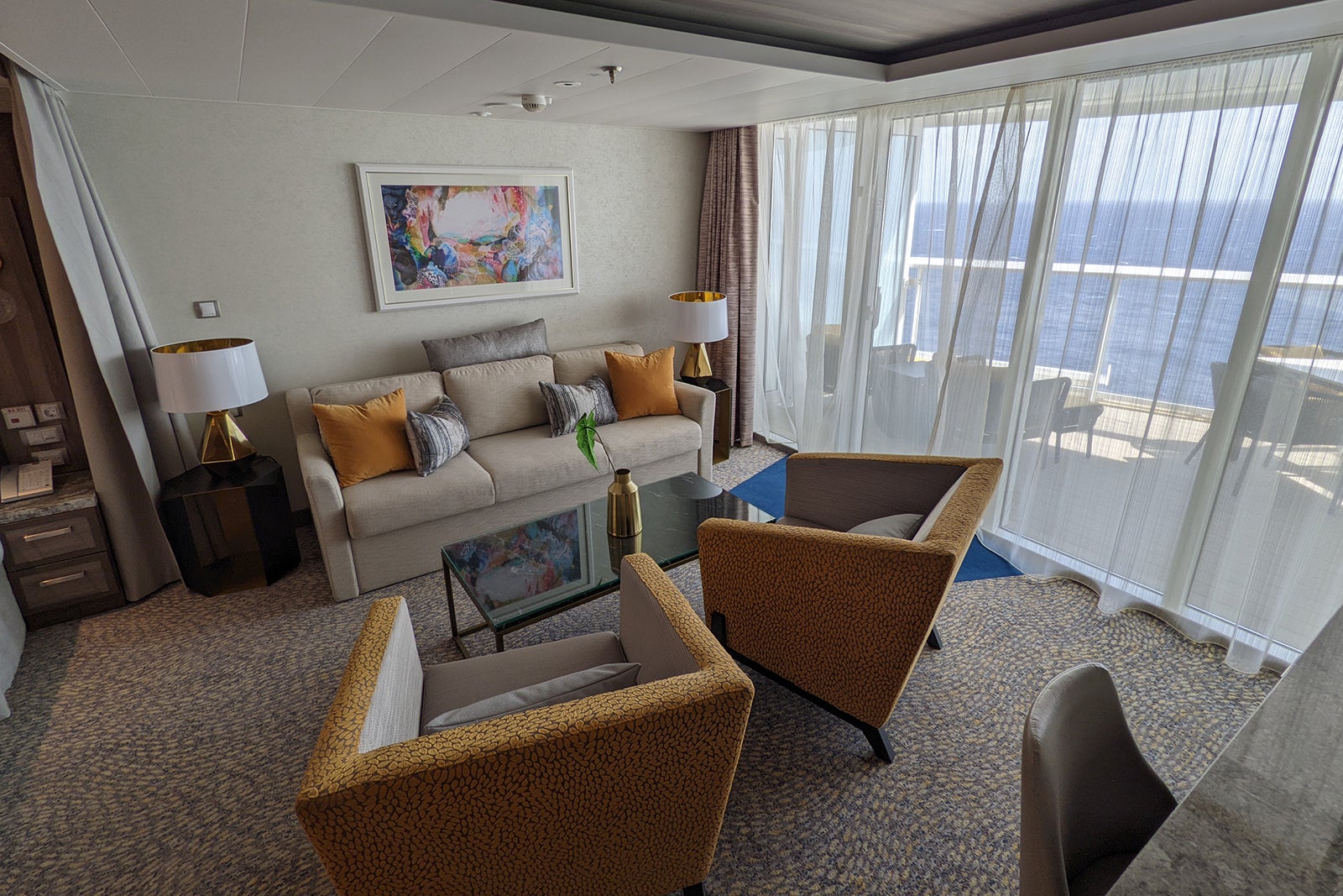 Couch, coffee table and two chairs in cruise ship suite