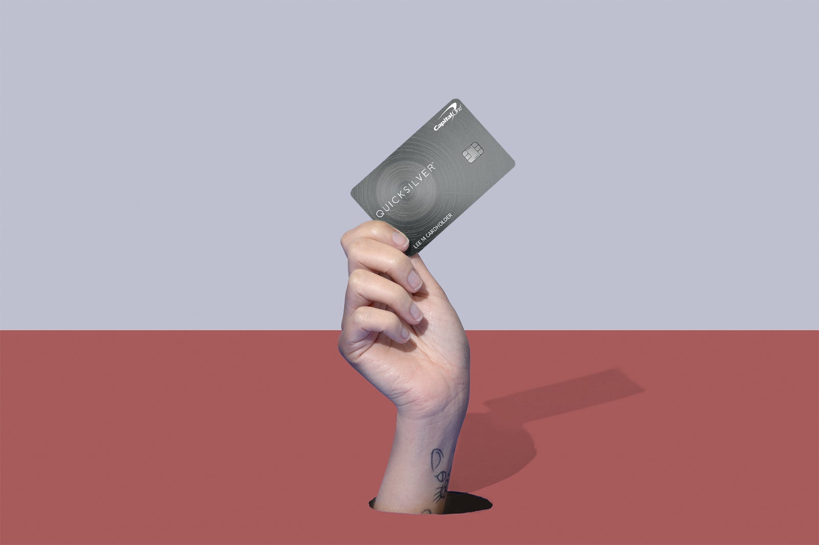 a hand holding a credit card
