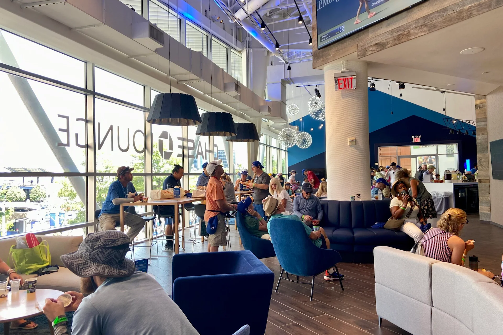 People inside a lounge, eating and drinking