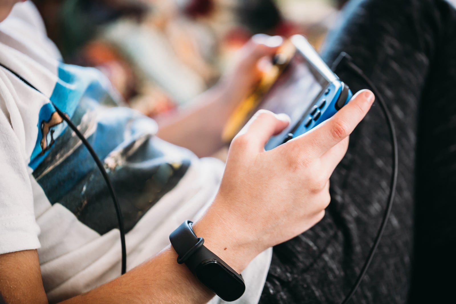 Close up of boy hands with a smart watch playing videogames