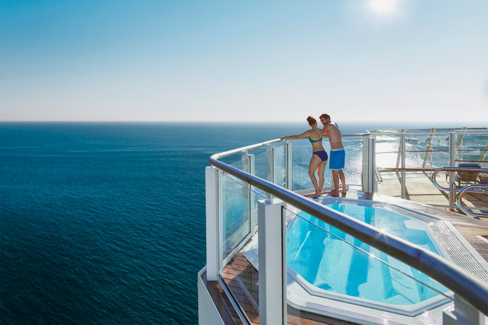 Man and women in swimsuits by hot tub on cruise ship deck in the Caribbean