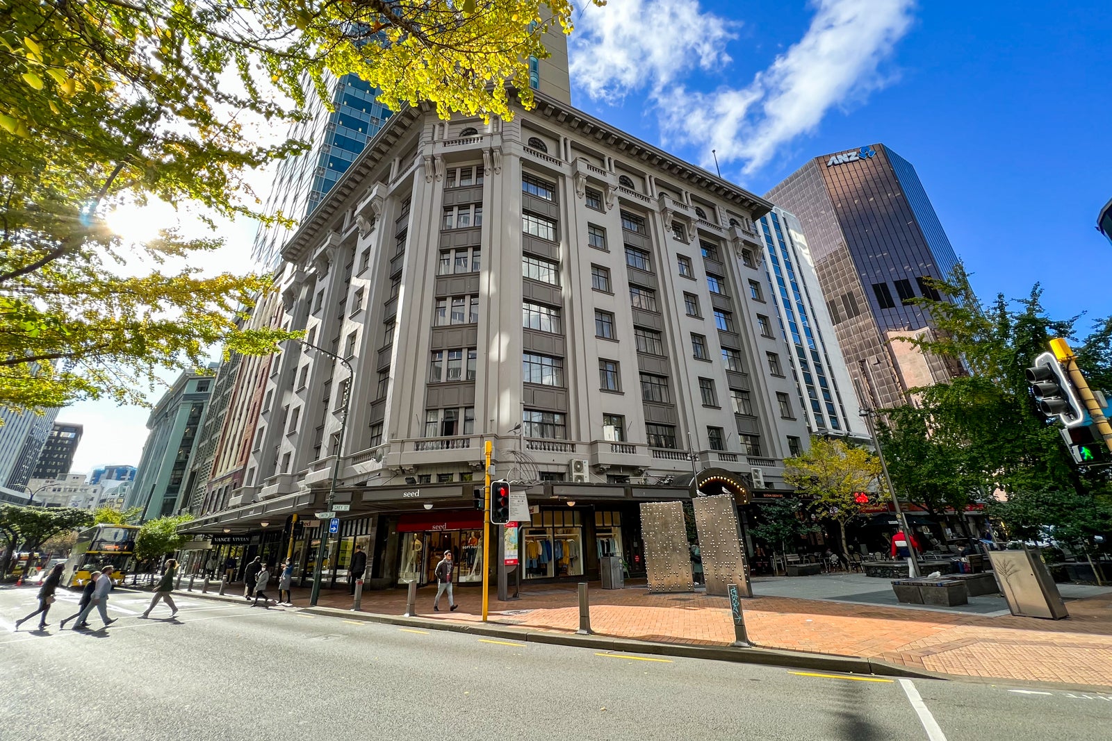 a street view of a historic building housing a hotel above shops on the first floor