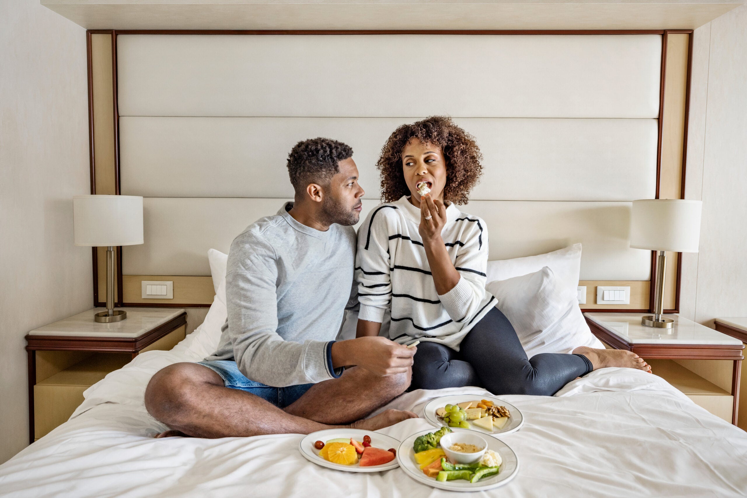 A couple having a room service meal on a cruise ship