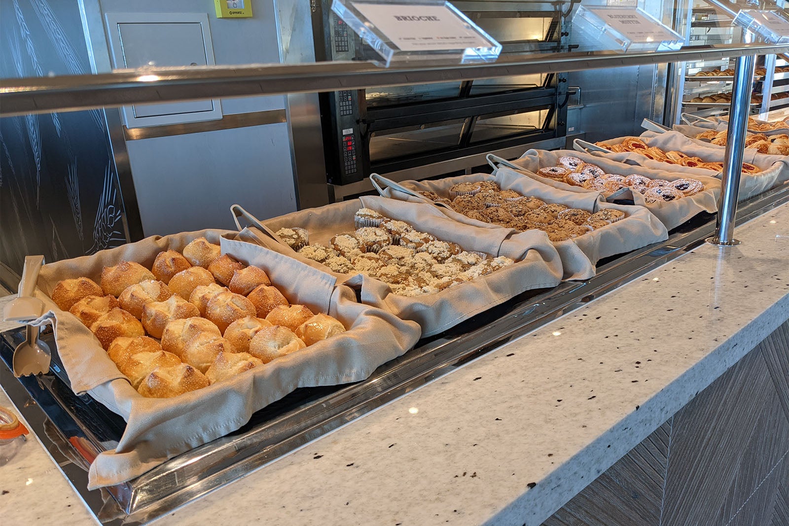 Buffet station with brioche rolls and breakfast pastries