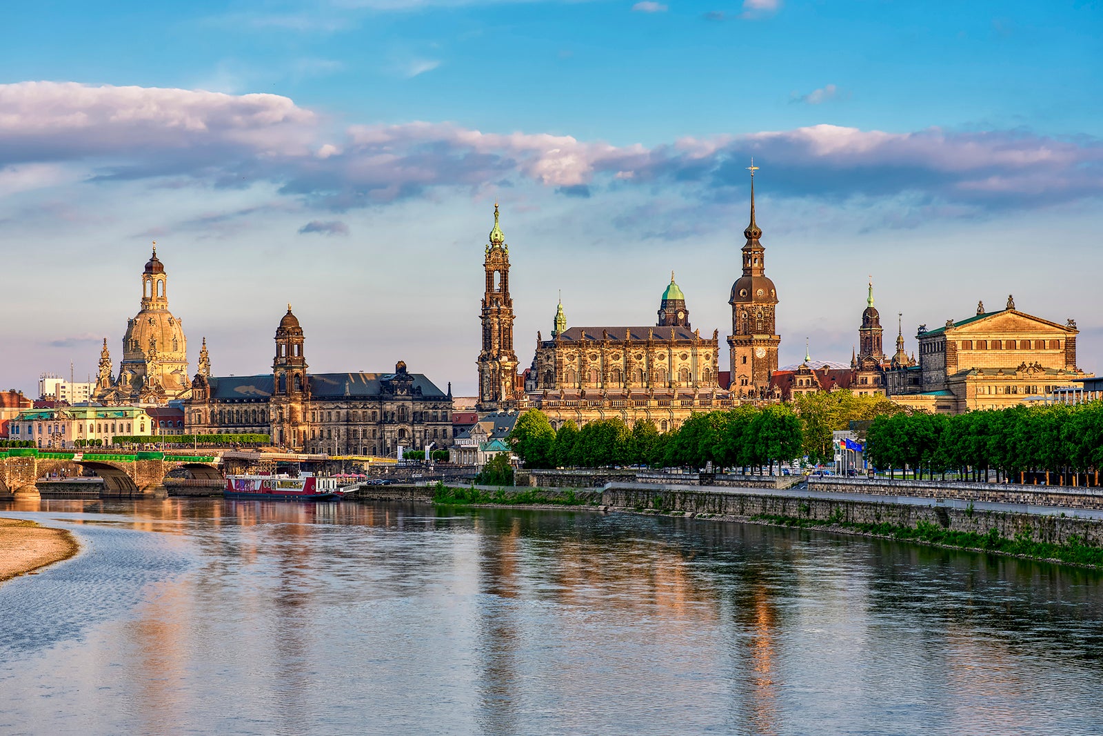 Several historic buildings line the riverside along the Elbe