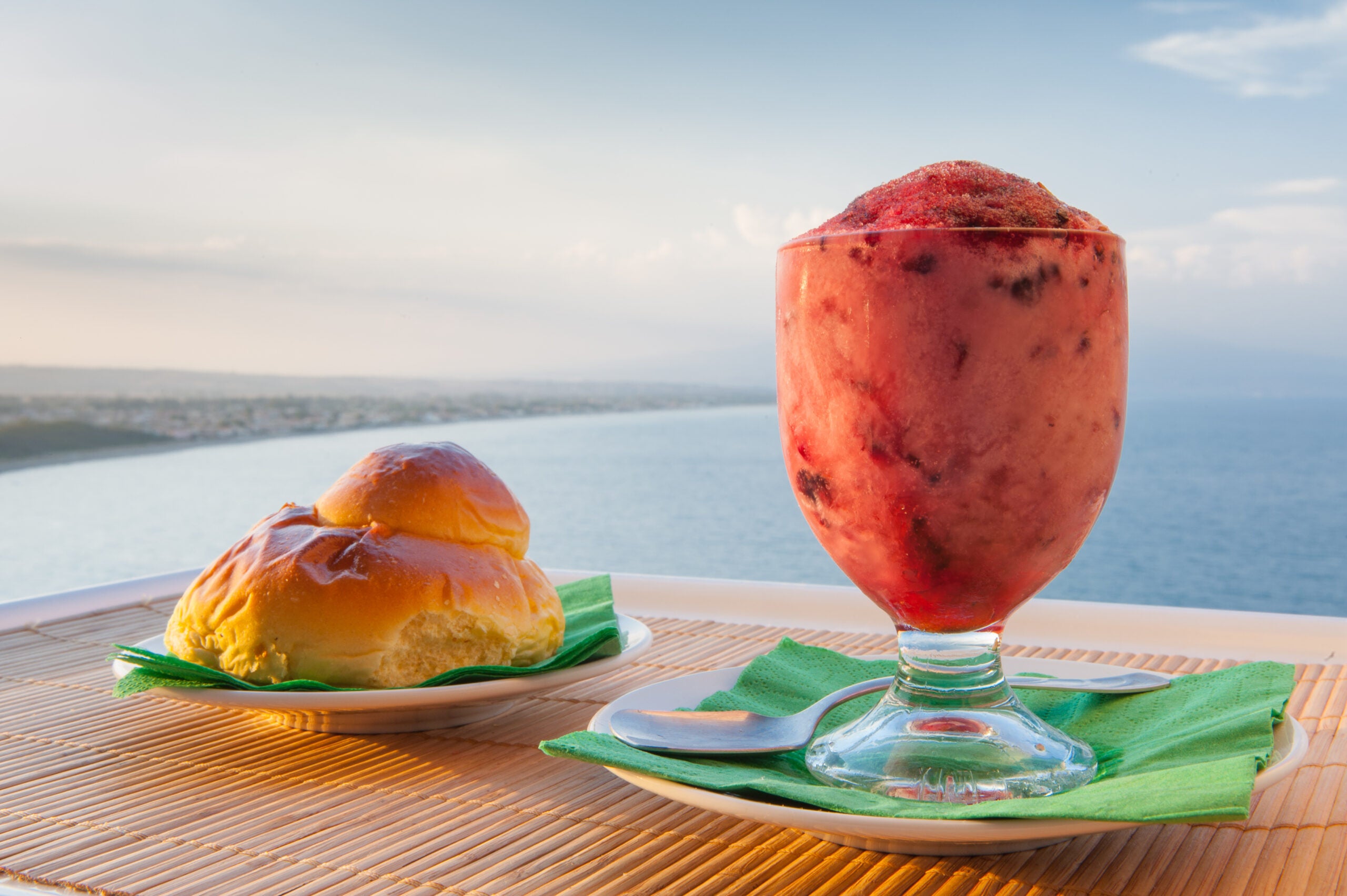 Granita and brioche with Mount Etna in background