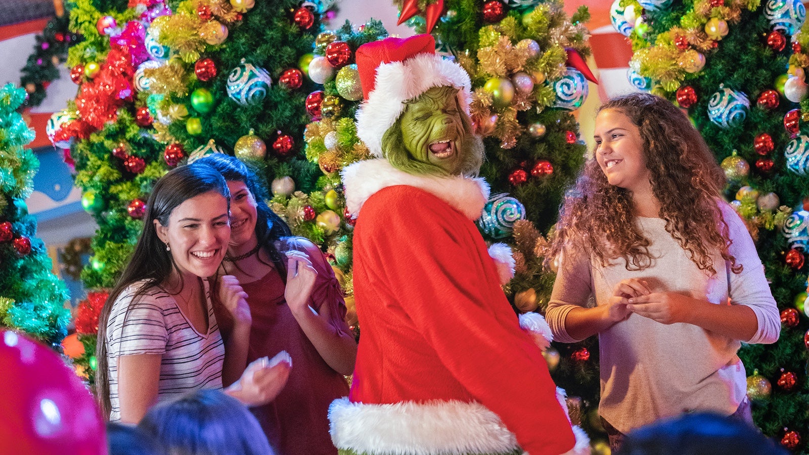 The Grinch posing with guests at Universal Orlando Resort