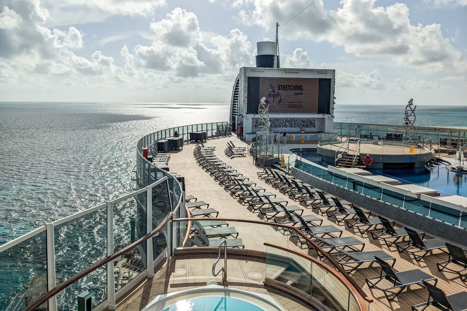 Top deck of MSC Seashore with lounge chairs and movie screen