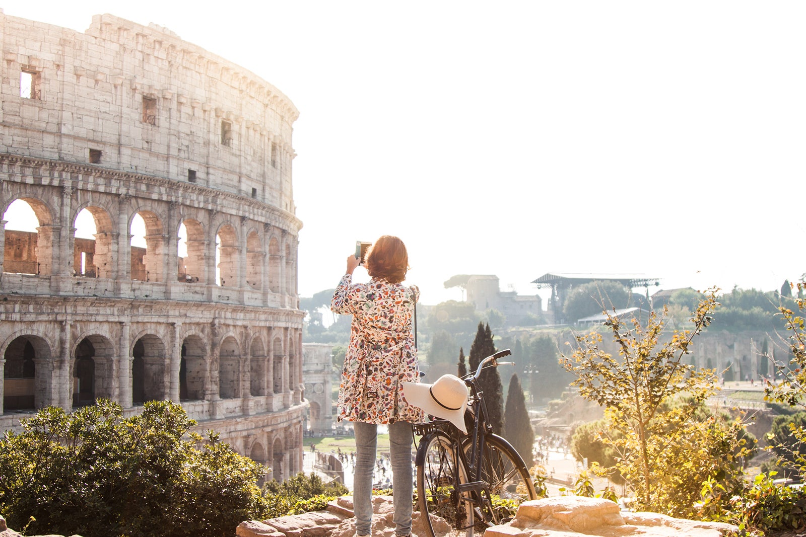 A woman sees the sights by bicycle in Rome