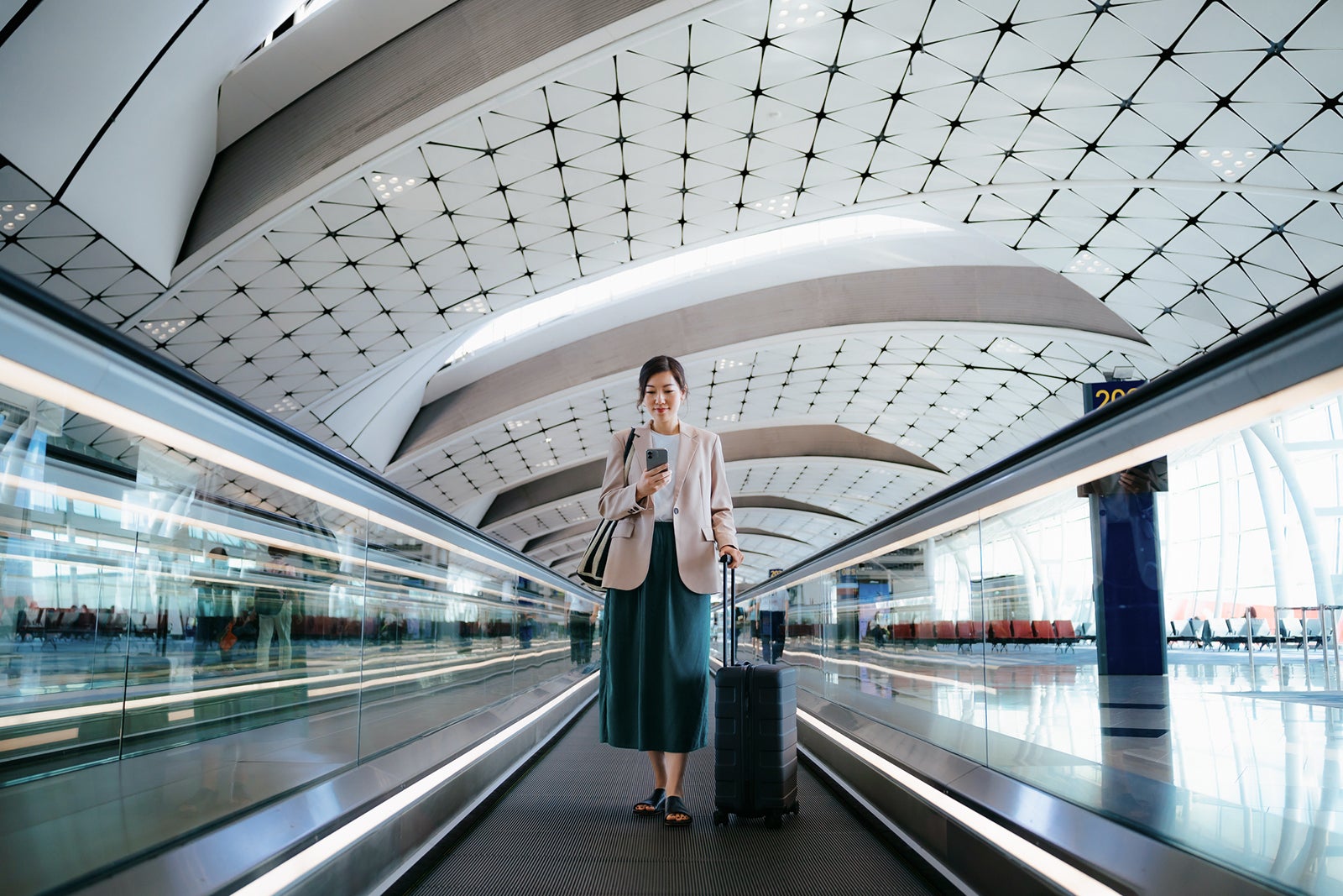 Woman in airport with suitcase